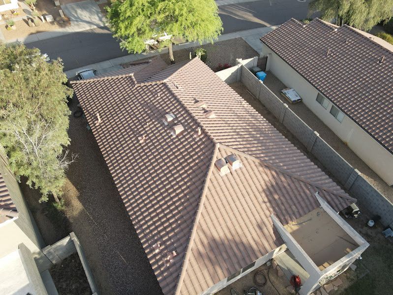 An aerial view of a house with a brown tile roof.