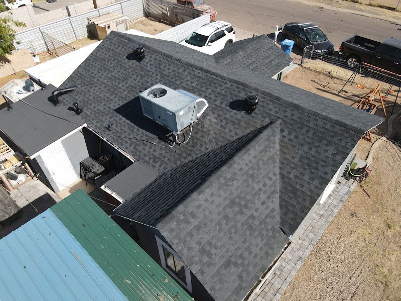 An aerial view of a roof of a house with a air conditioner on top of it.