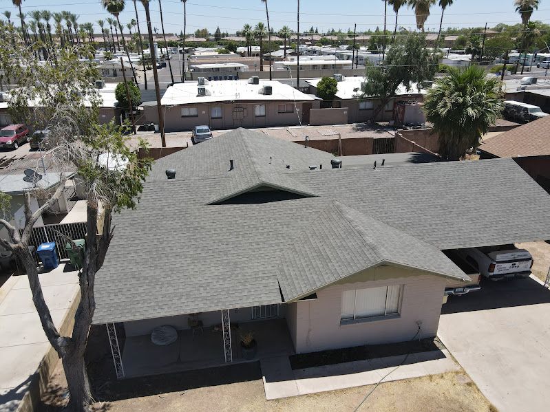 An aerial view of a house with a gray roof.