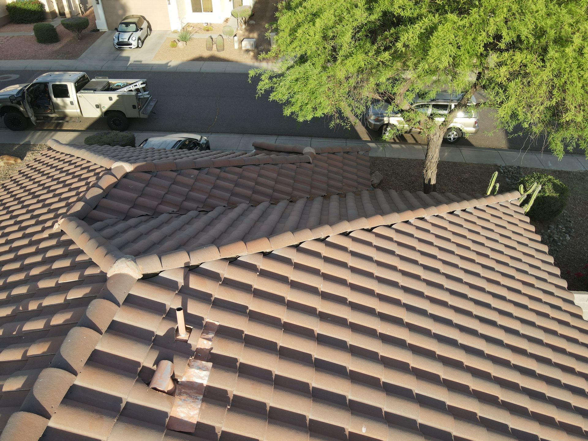 An aerial view of a tiled roof in a residential area.