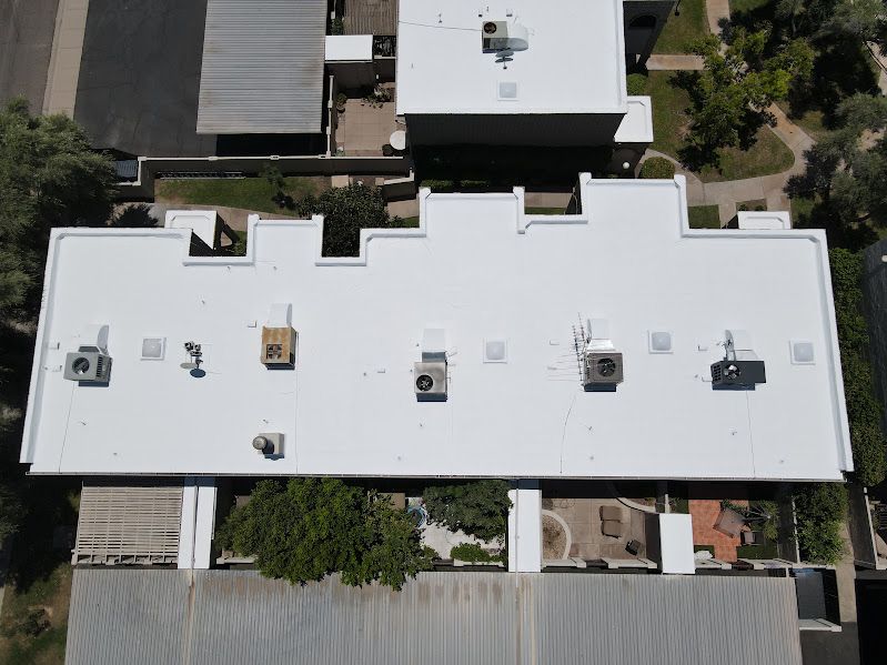 An aerial view of a building with a white roof.