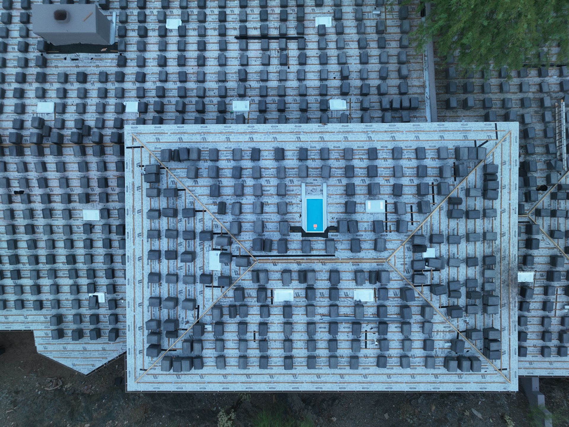 An aerial view of a house with a lot of tiles on the roof.