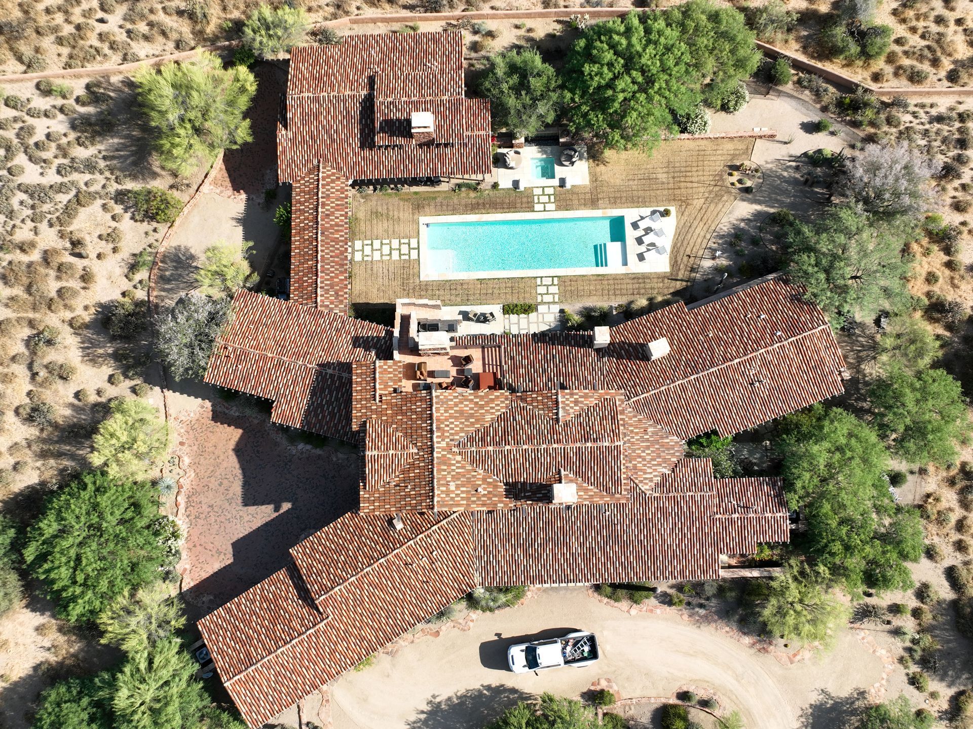 An aerial view of a large house with a pool.