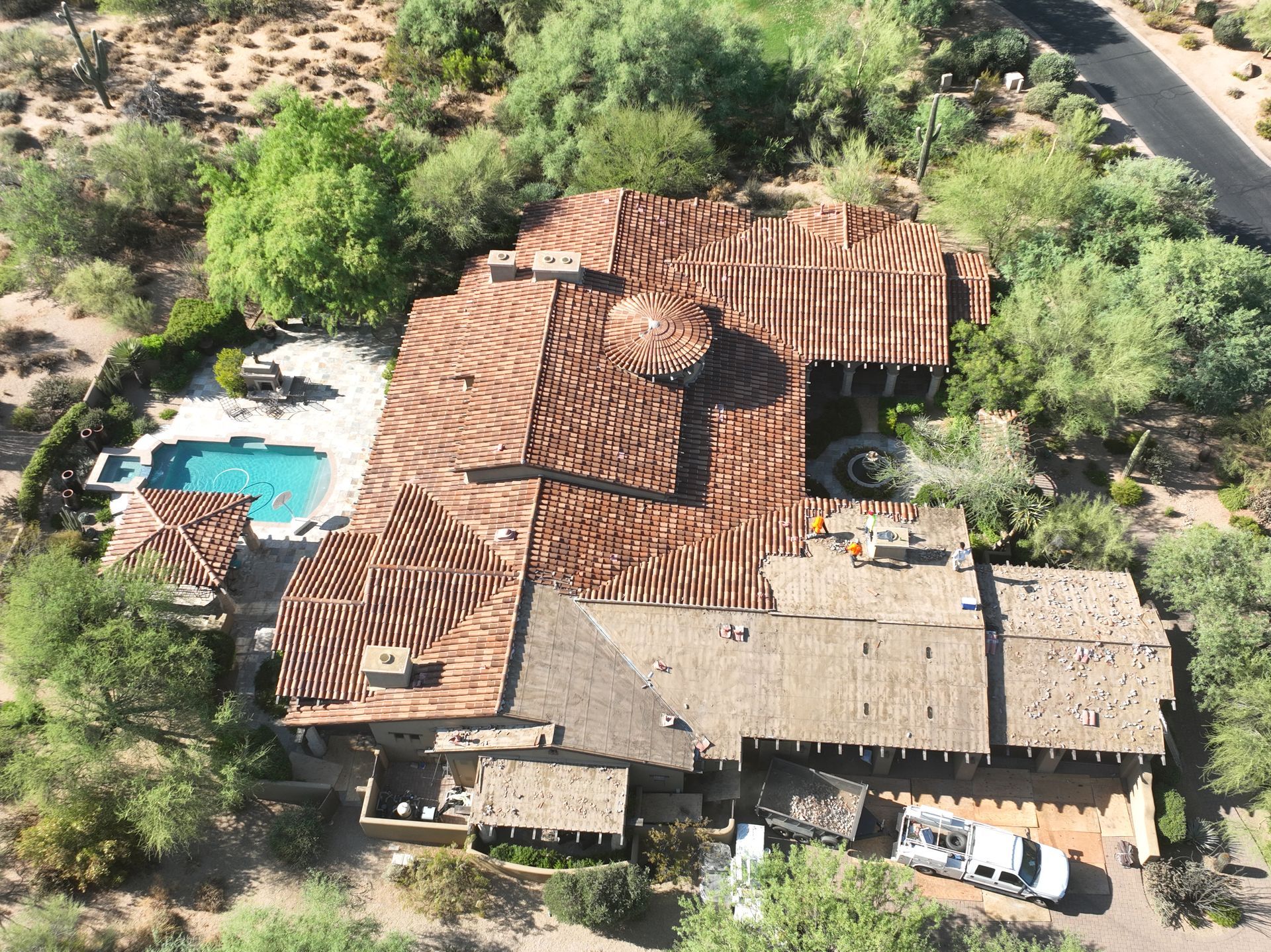 An aerial view of a large house with a pool.