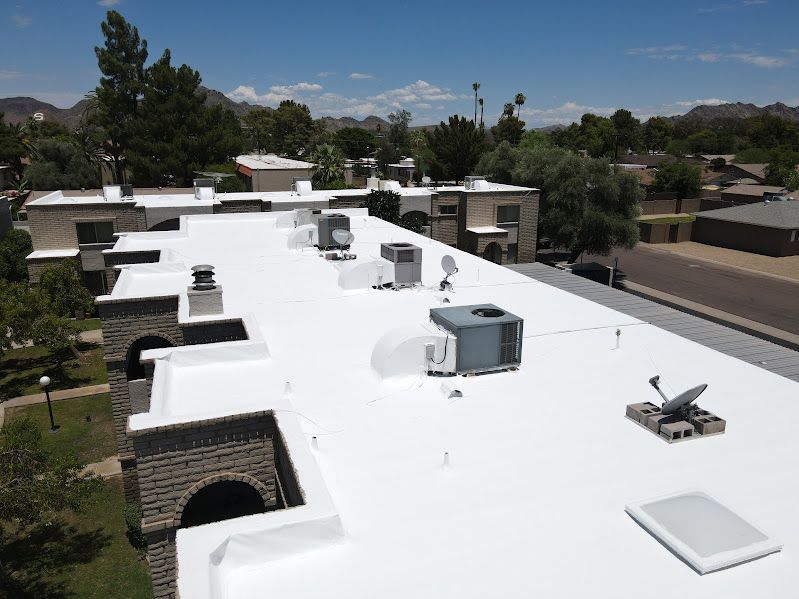 A white roof with a lot of air conditioners on it.