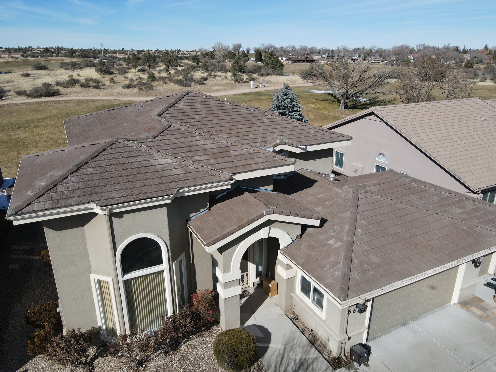 An aerial view of a house with a brown roof.
