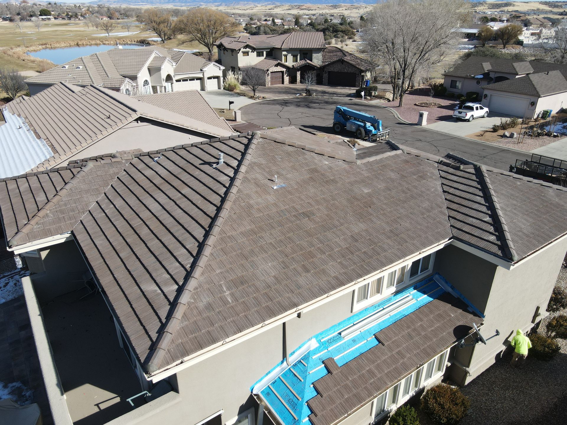An aerial view of a house with a roof that is being installed.
