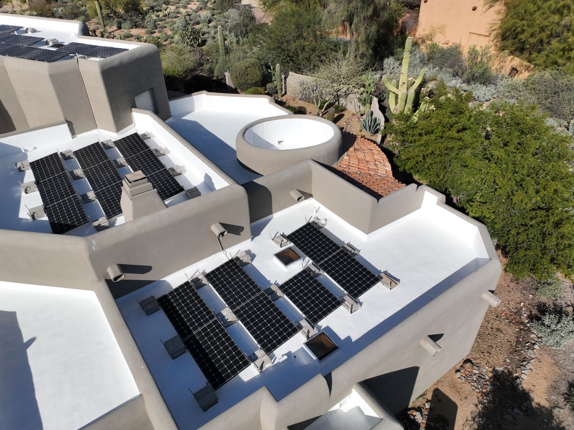 An aerial view of a house with solar panels on the roof.