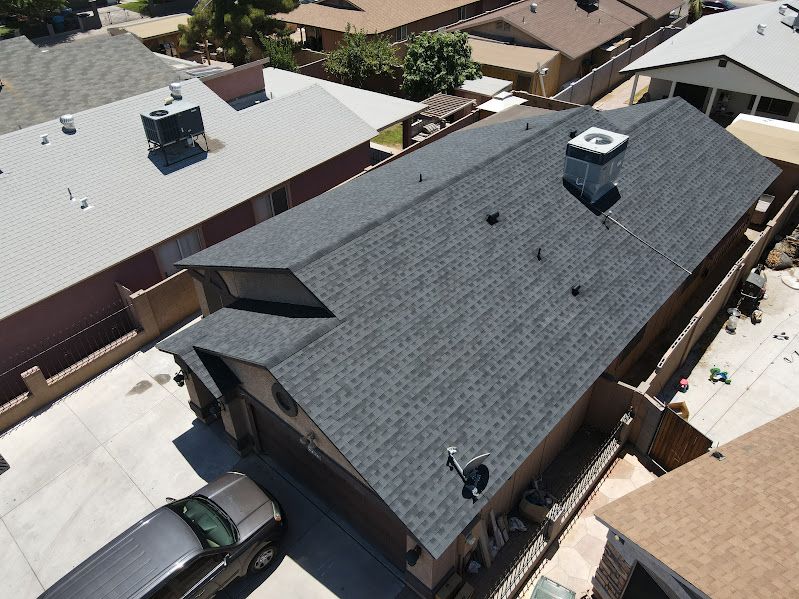 An aerial view of a house with a new roof.