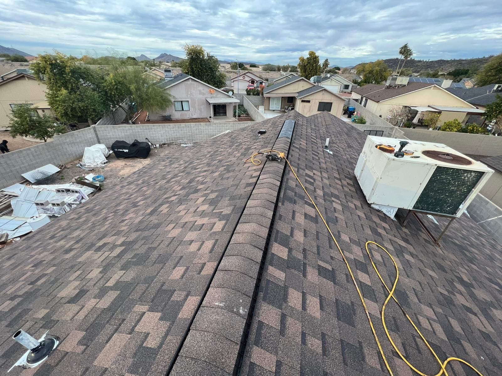 An aerial view of a roof with a air conditioner on top of it.