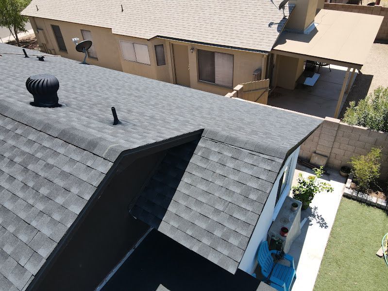 An aerial view of a roof of a house with a satellite dish on it.