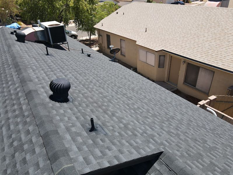 An aerial view of a roof of a house with a fan on it.