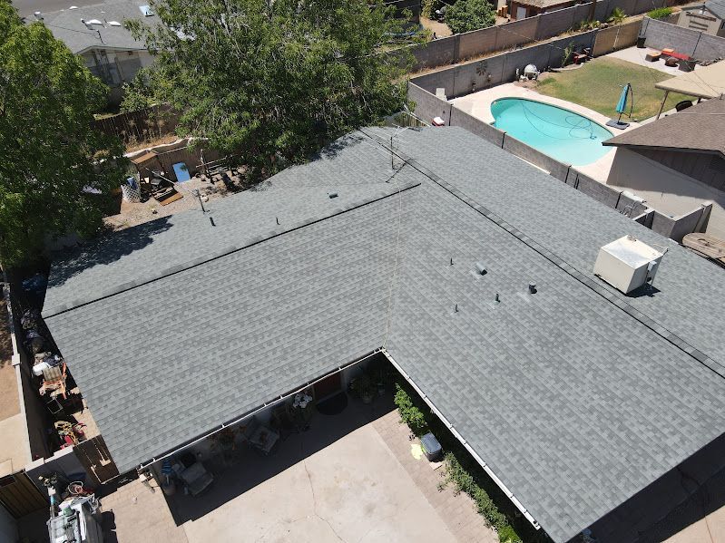 An aerial view of a house with a pool in the backyard.
