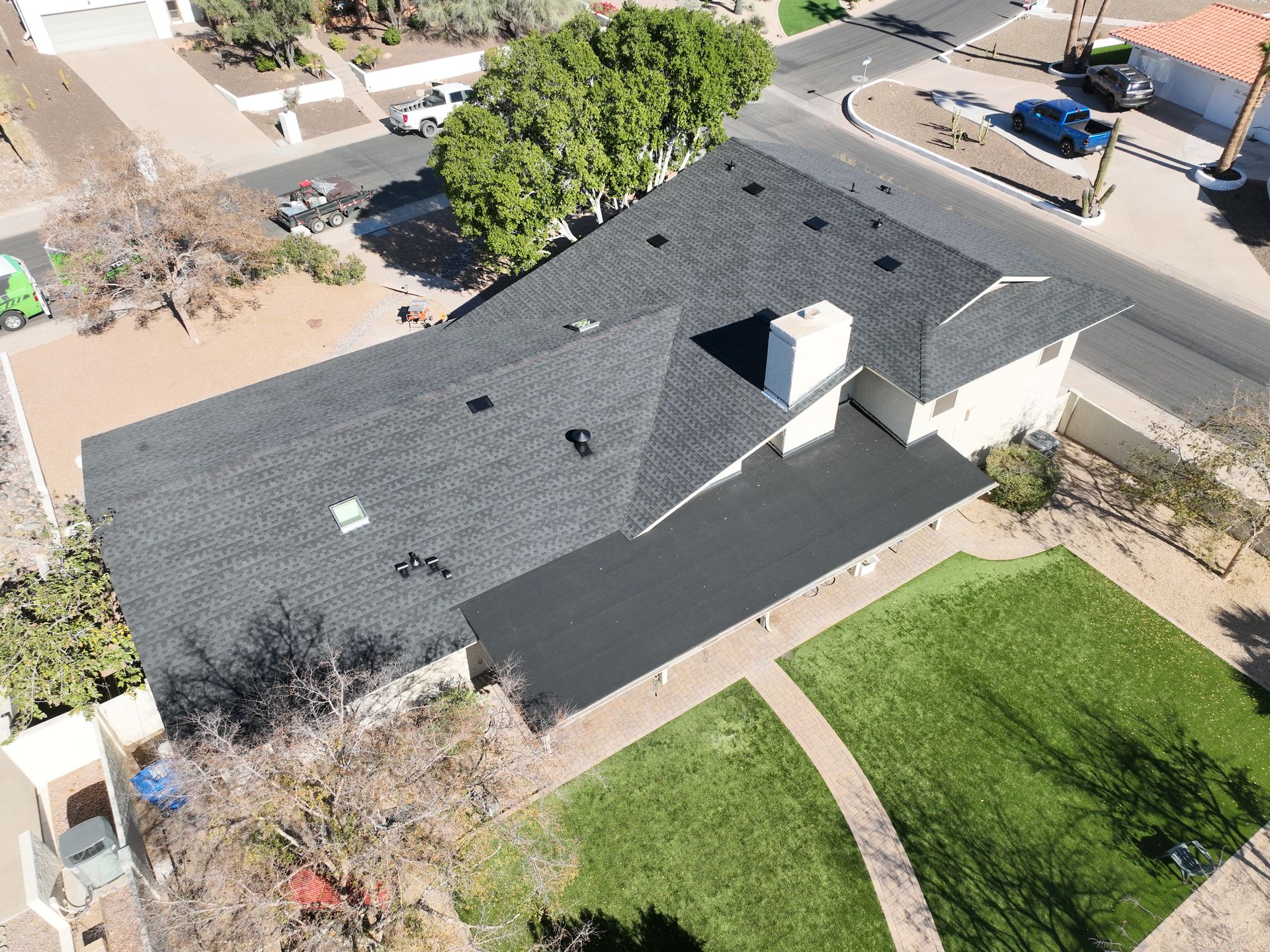 An aerial view of a house with a new roof.