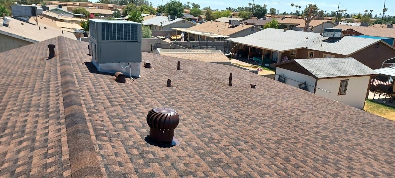 The roof of a house with a chimney on it.