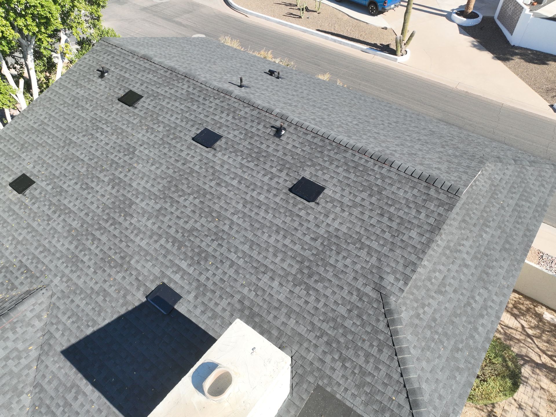 An aerial view of a roof with a chimney on it.