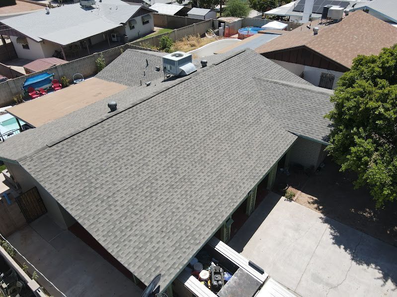 An aerial view of a house with a new roof.