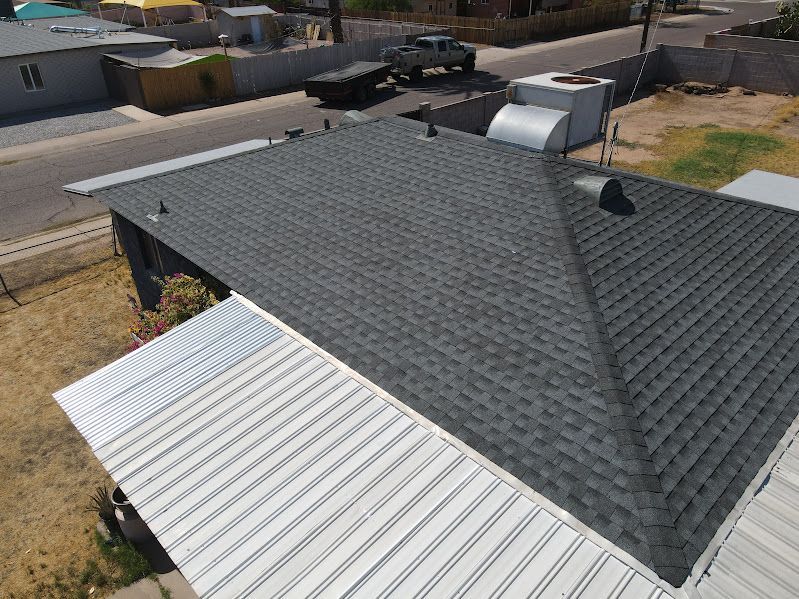 An aerial view of a house with a gray roof.