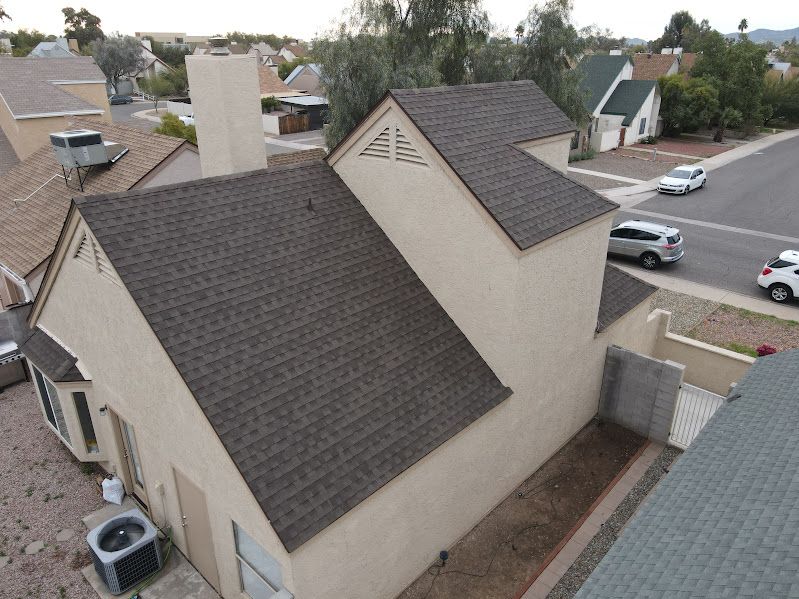 An aerial view of a house with a new roof.