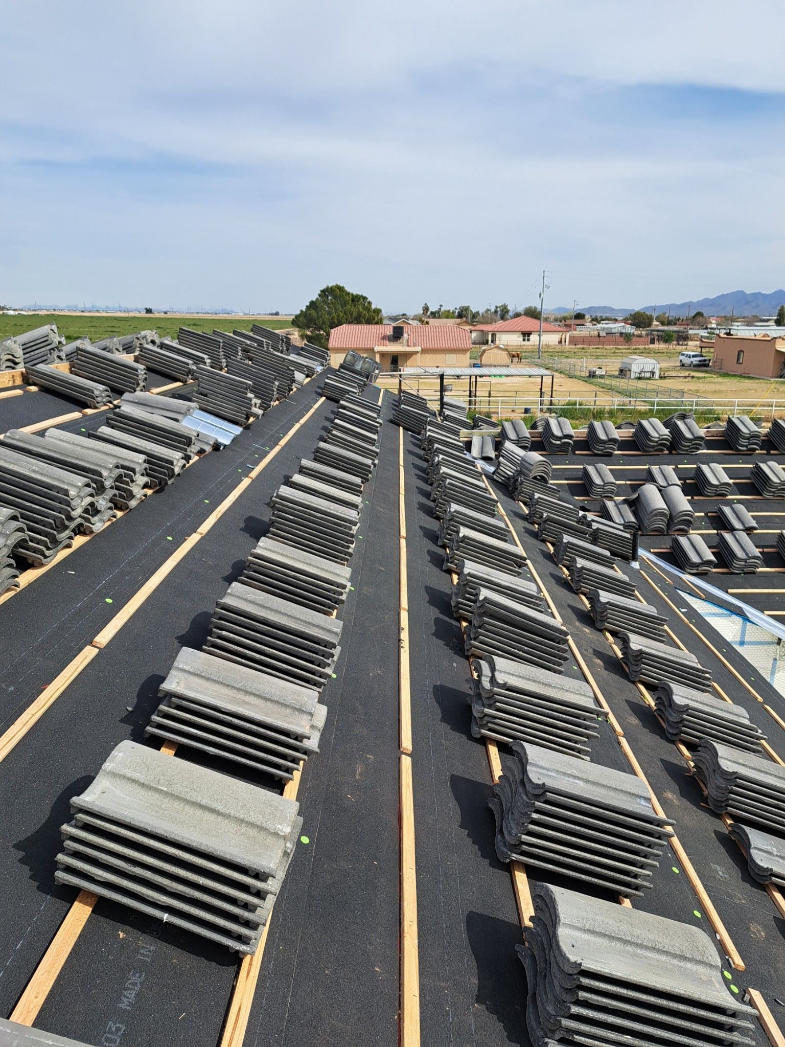 Concrete tiles roofing is stacked on top of each other.