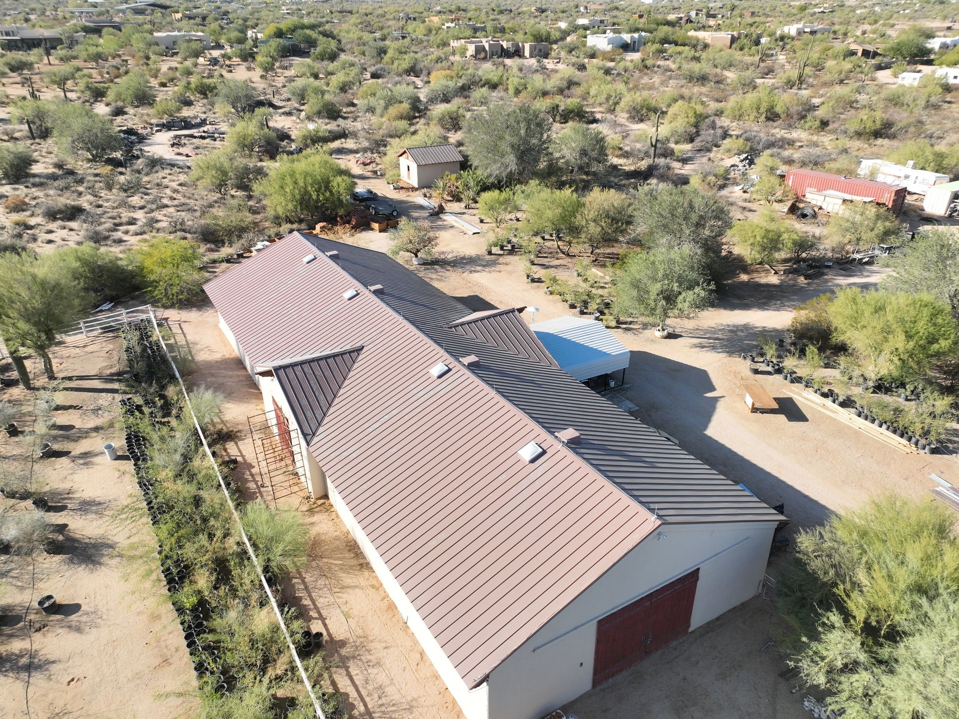 An aerial view of a house with a brown roof.