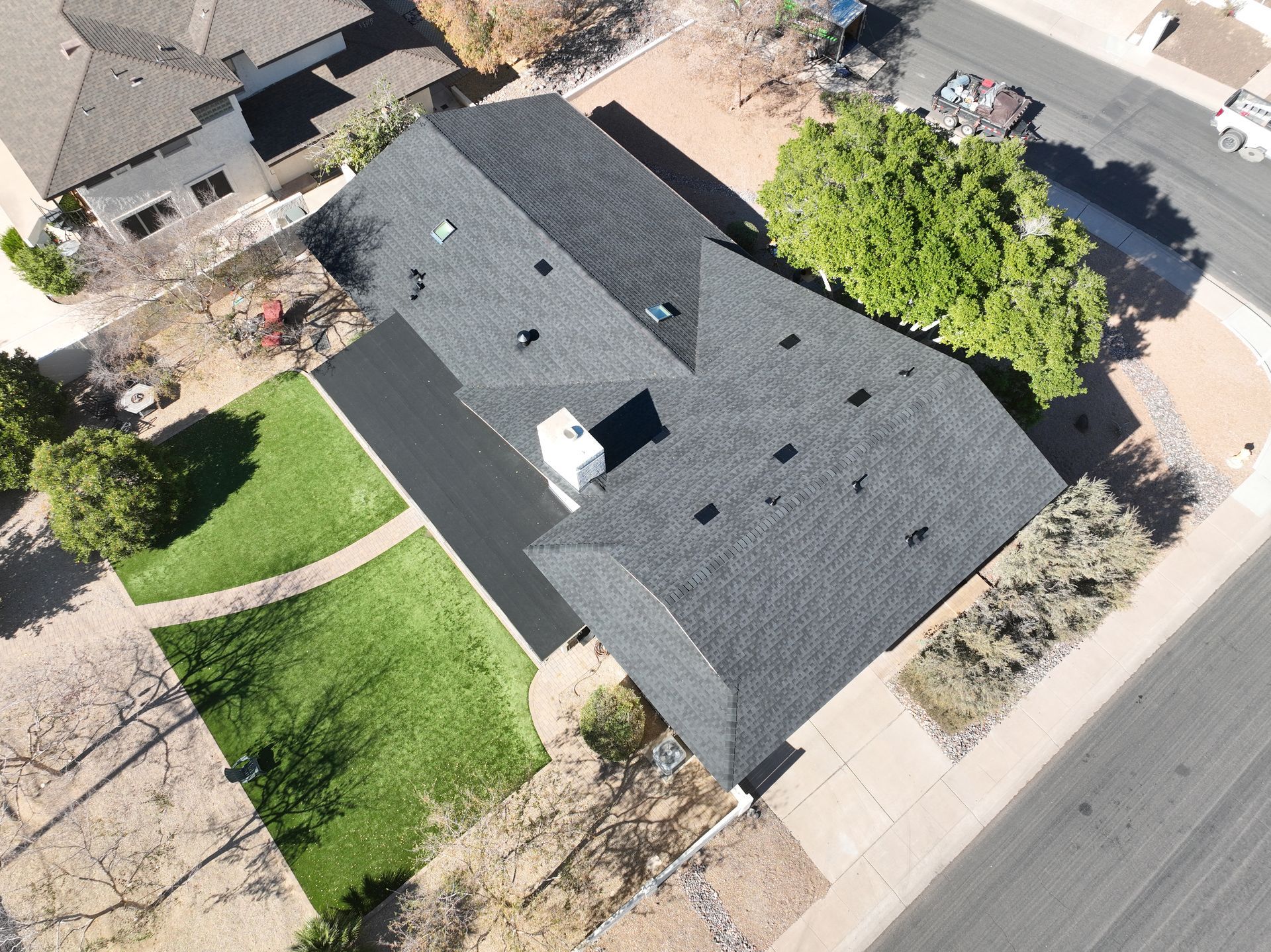 An aerial view of a house with a black roof.
