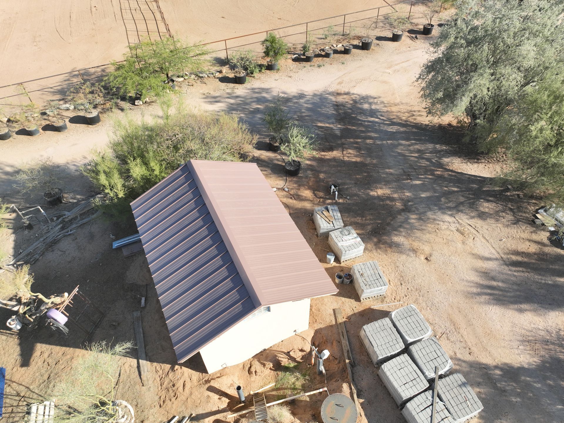 An aerial view of a house with solar panels on the roof.