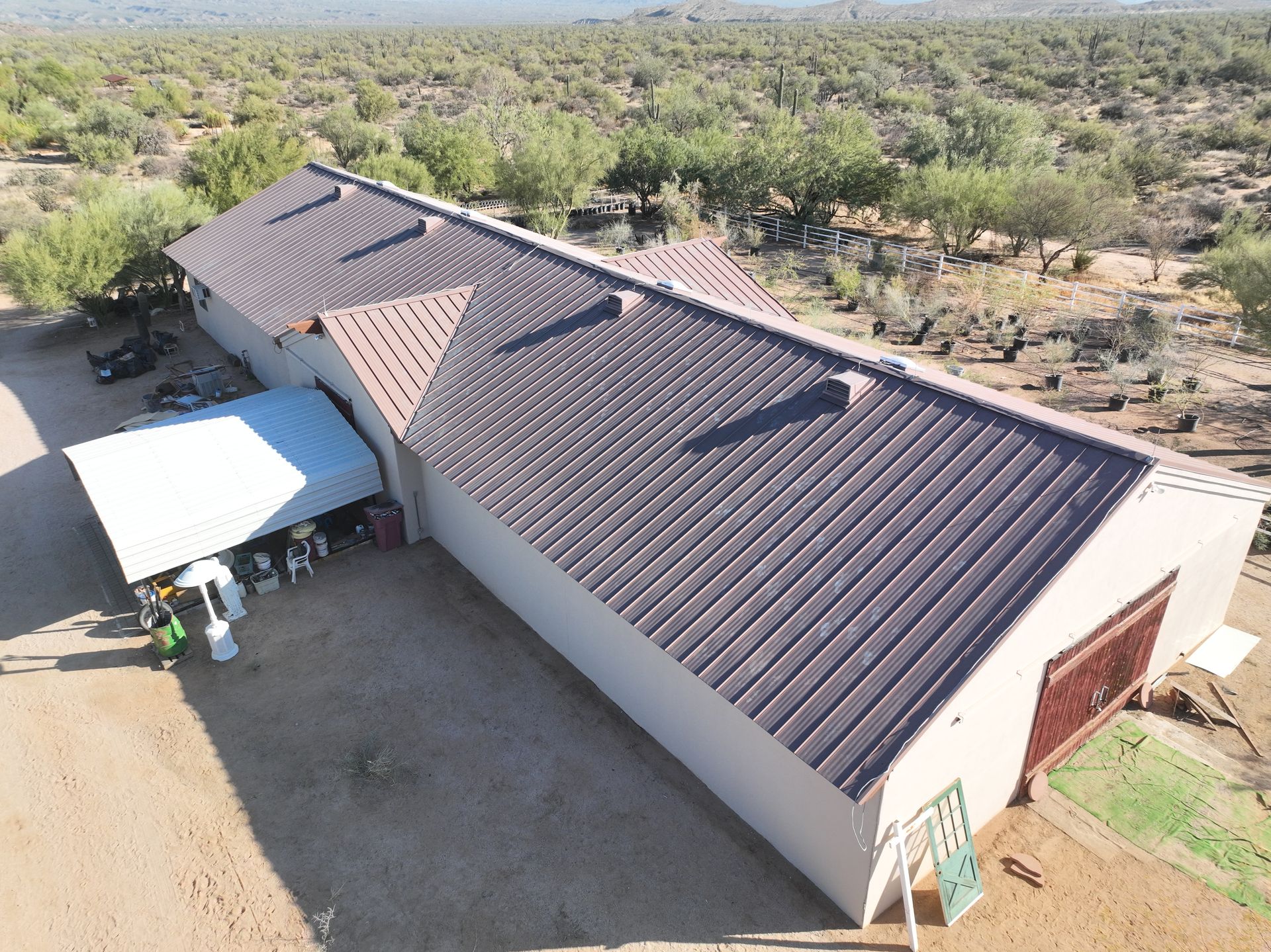 An aerial view of a building with a brown roof.
