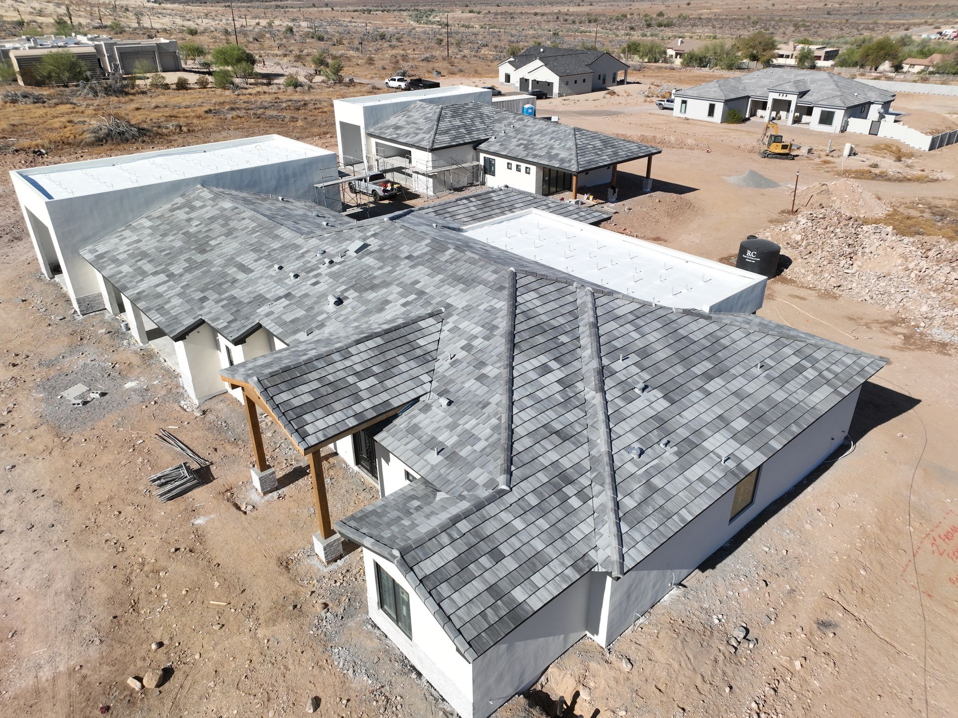 An aerial view of a row of houses under construction in the desert.