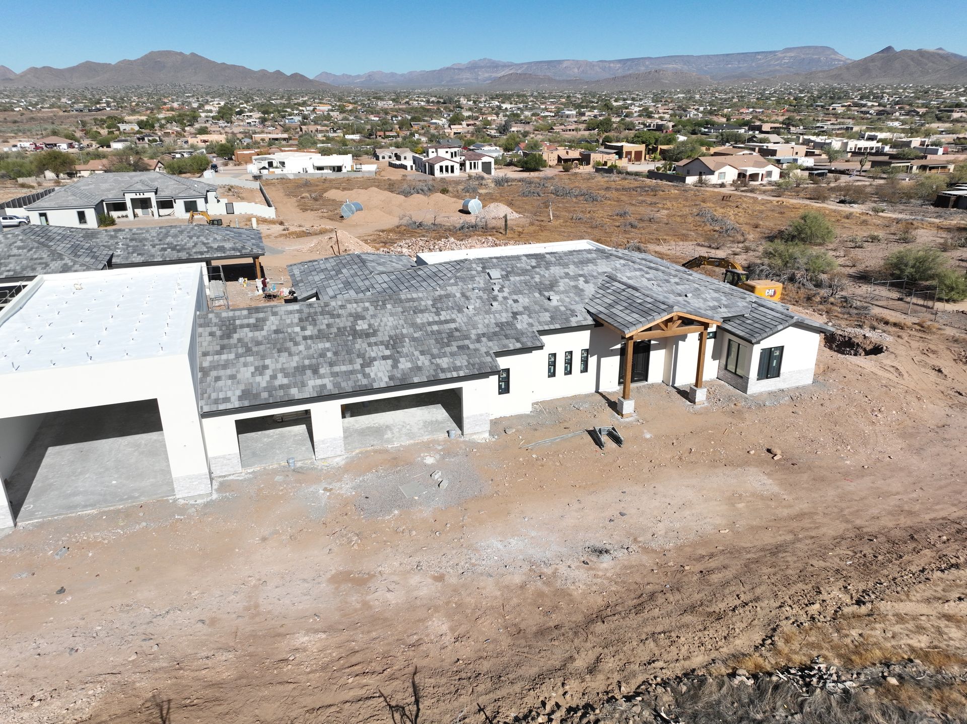 An aerial view of a house under construction in the desert.
