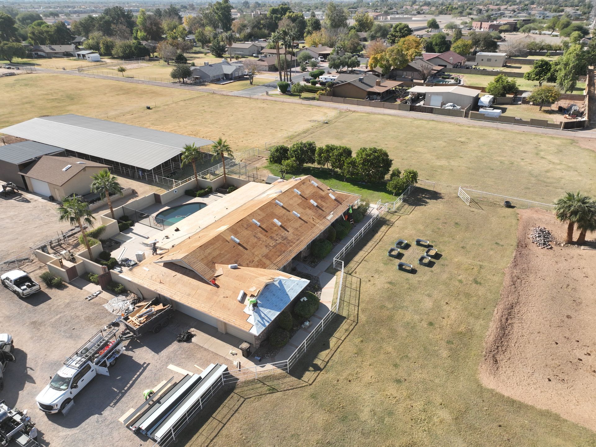 An aerial view of a house under construction in a residential area.