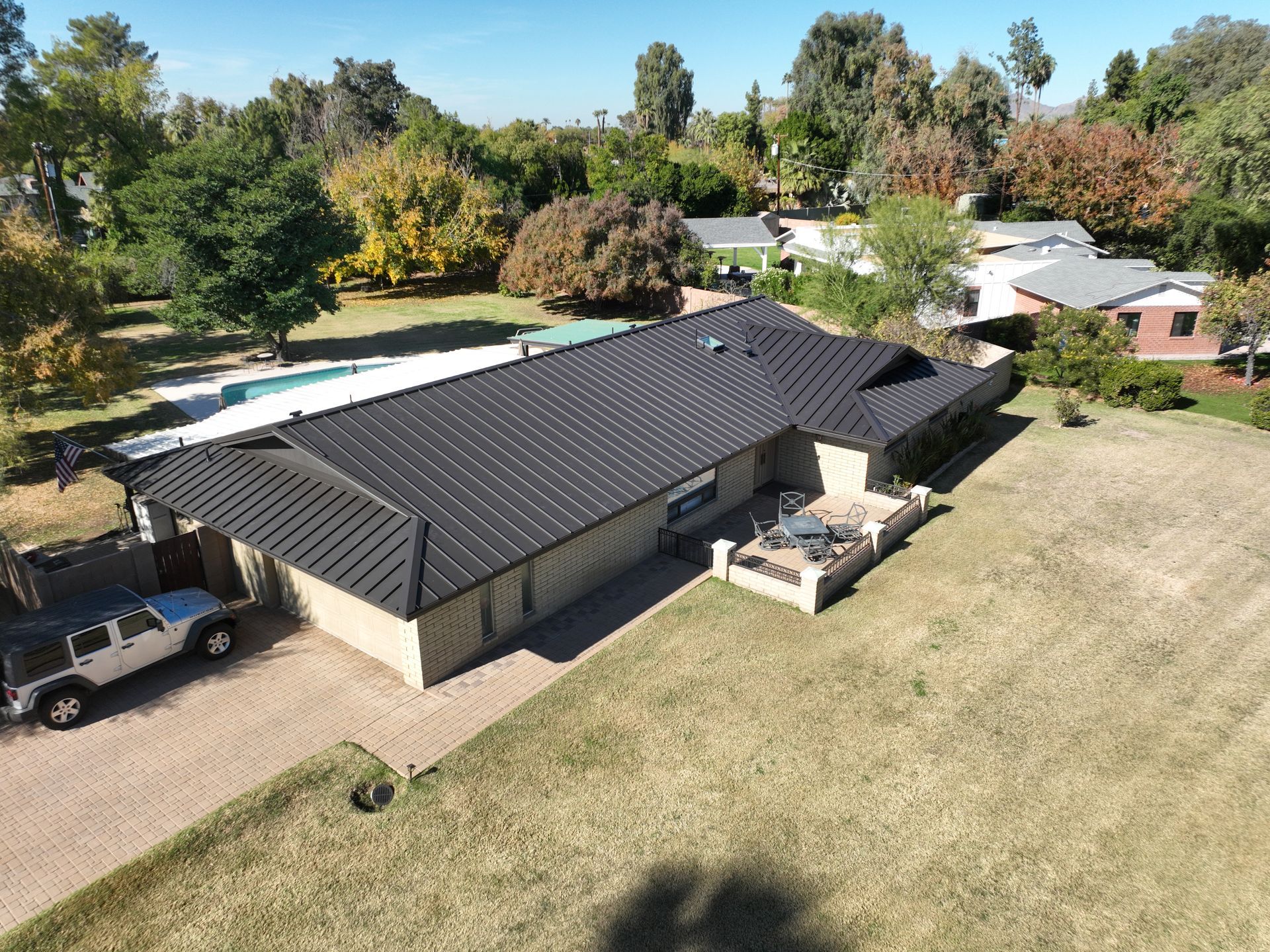 An aerial view of a house with a black roof.
