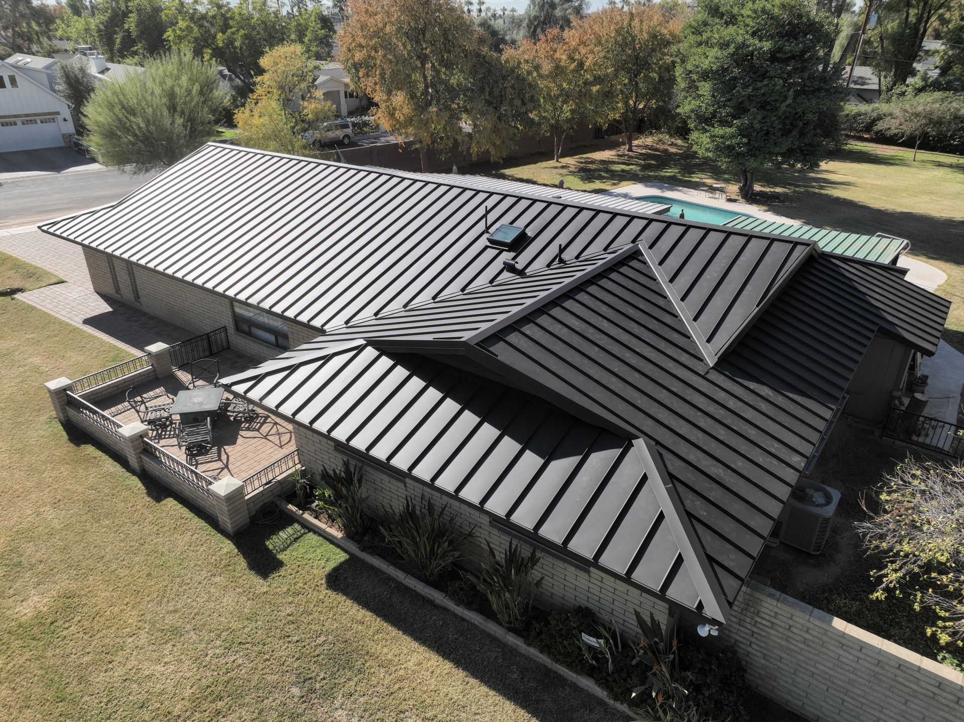 An aerial view of a house with a metal roof.
