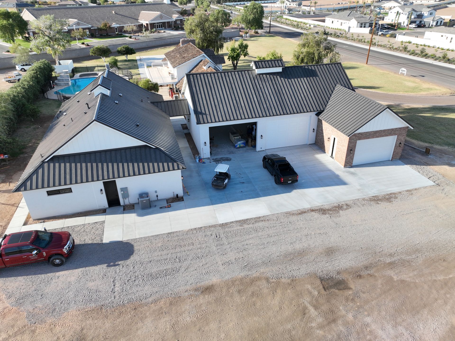 An aerial view of a house with a red truck parked in front of it.