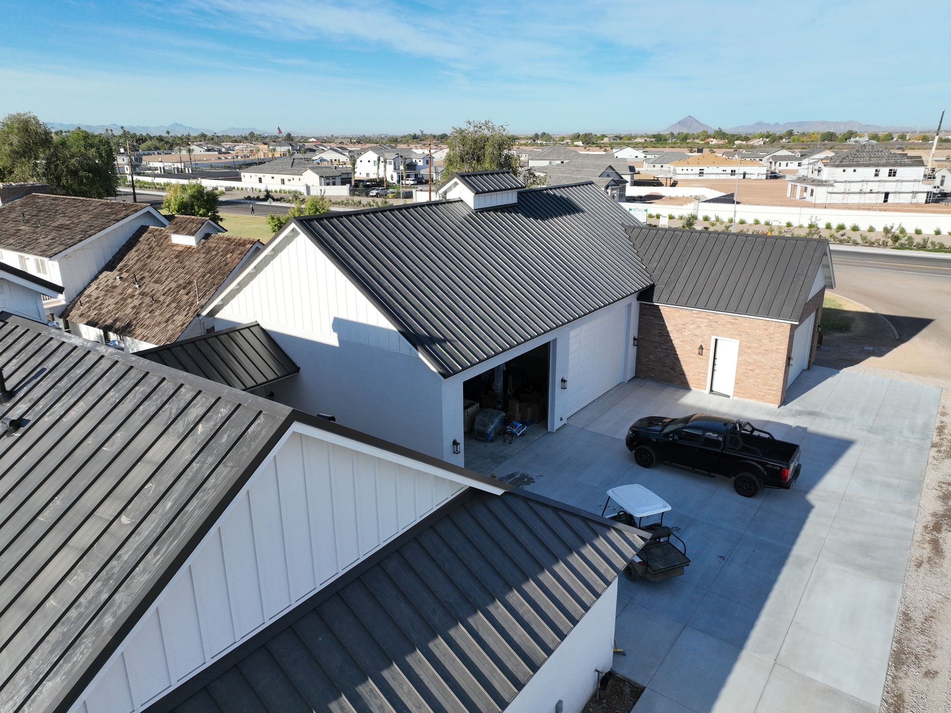 An aerial view of a house with a black truck parked in front of it.