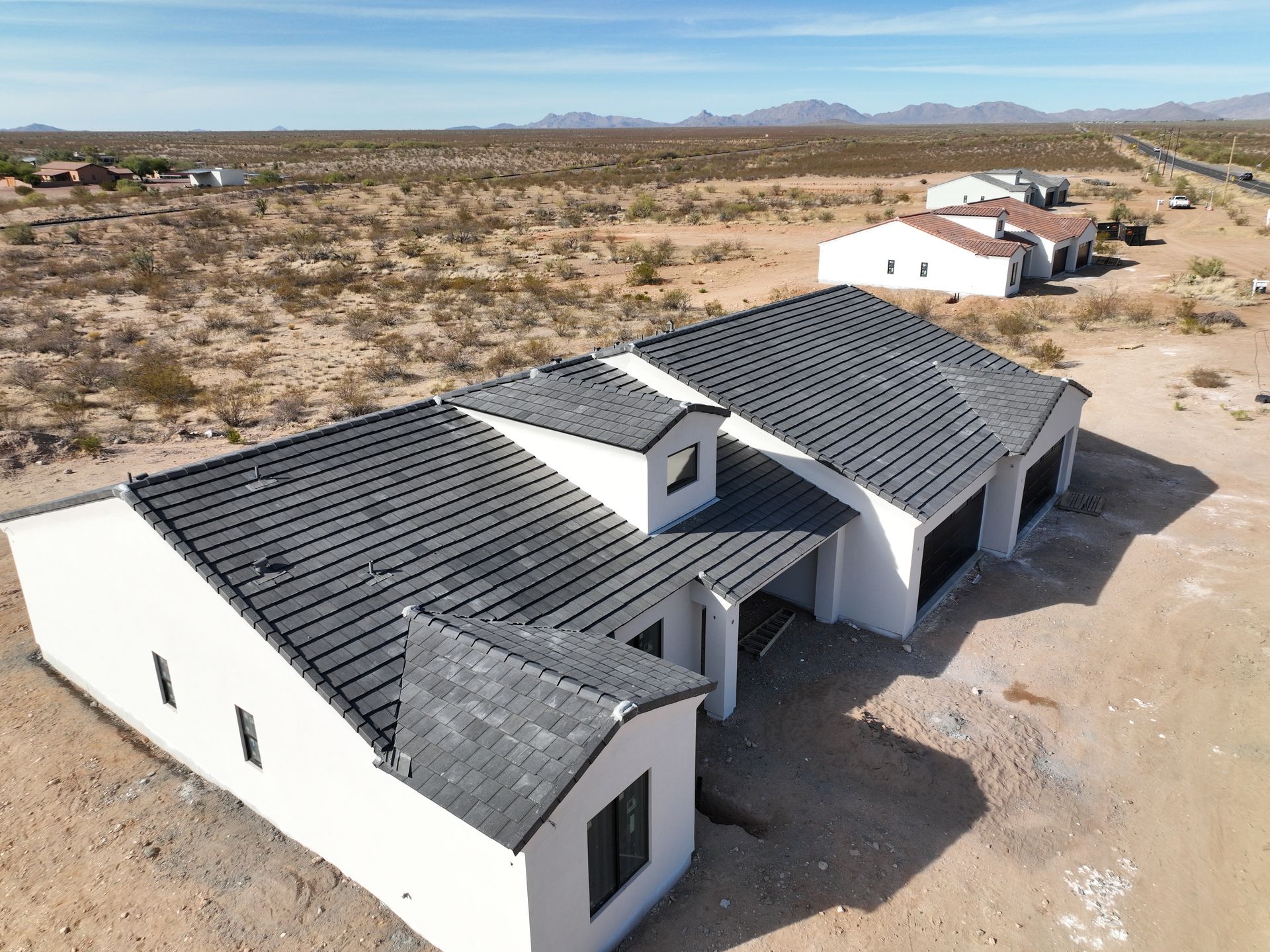 An aerial view of a row of houses in the desert.