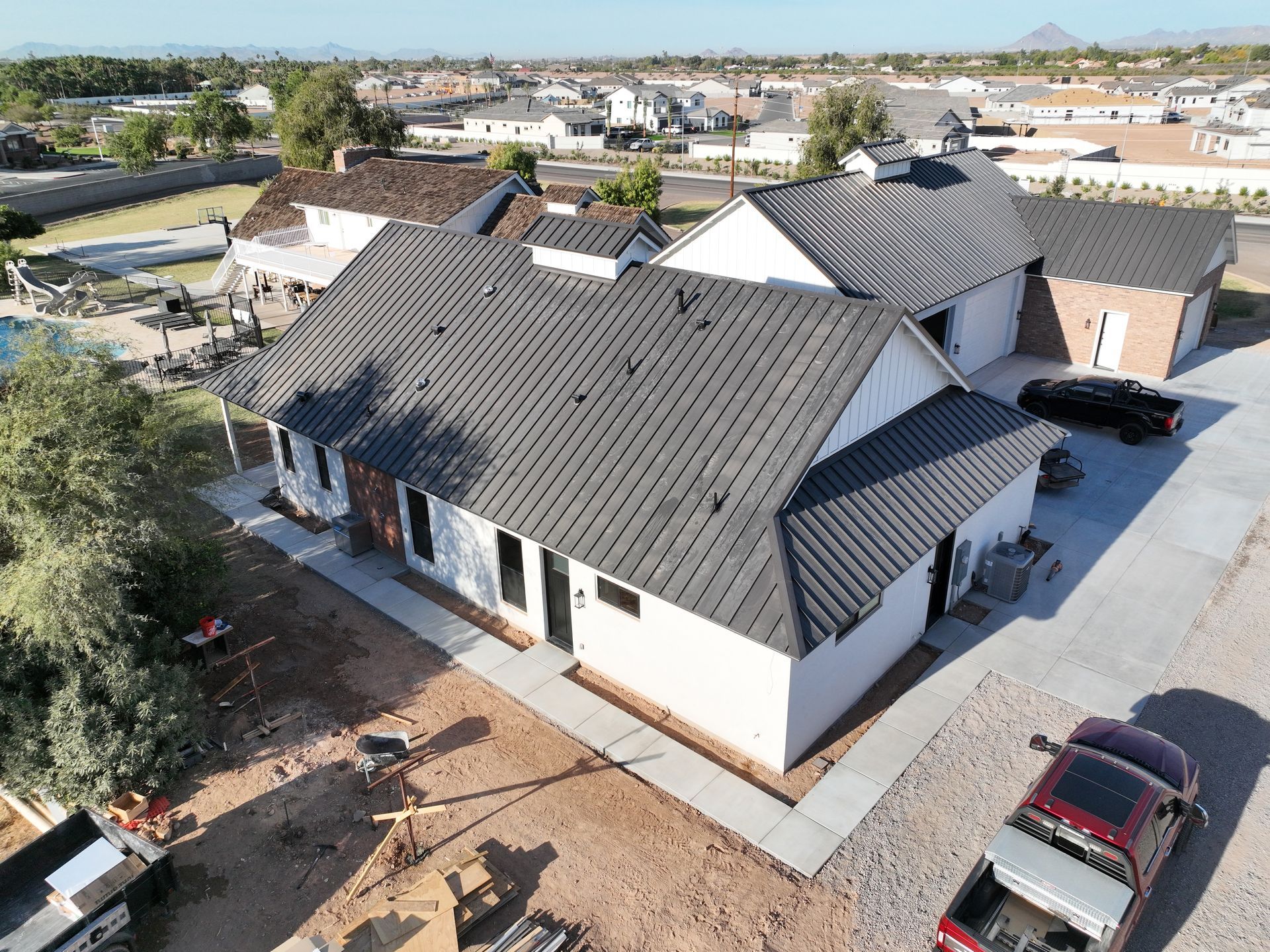 An aerial view of a house under construction with a black roof.