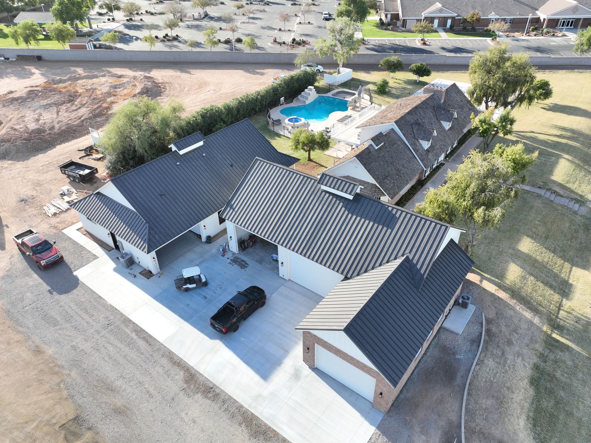 An aerial view of a house with a pool in the backyard.