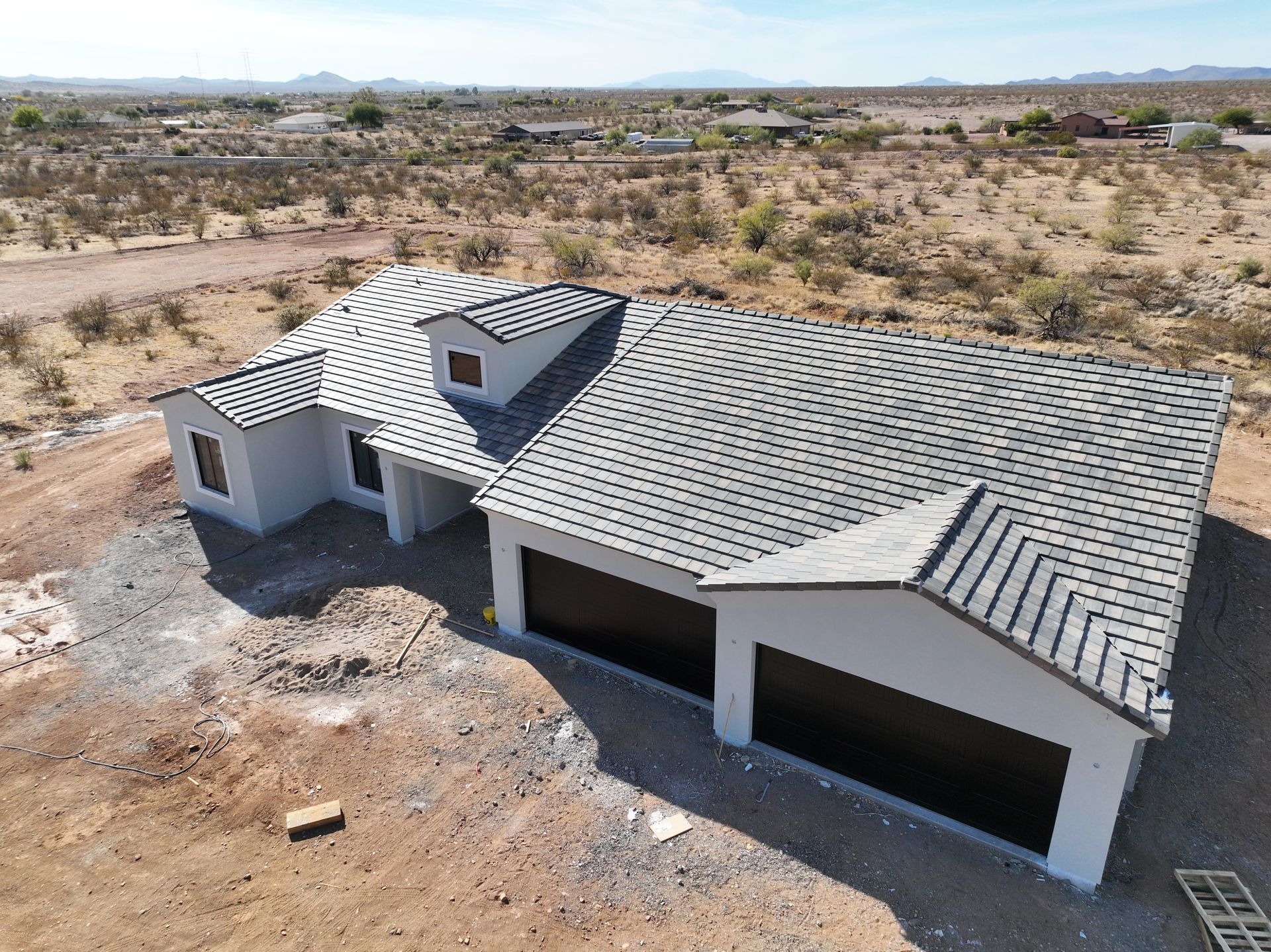 An aerial view of a house under construction in the desert.
