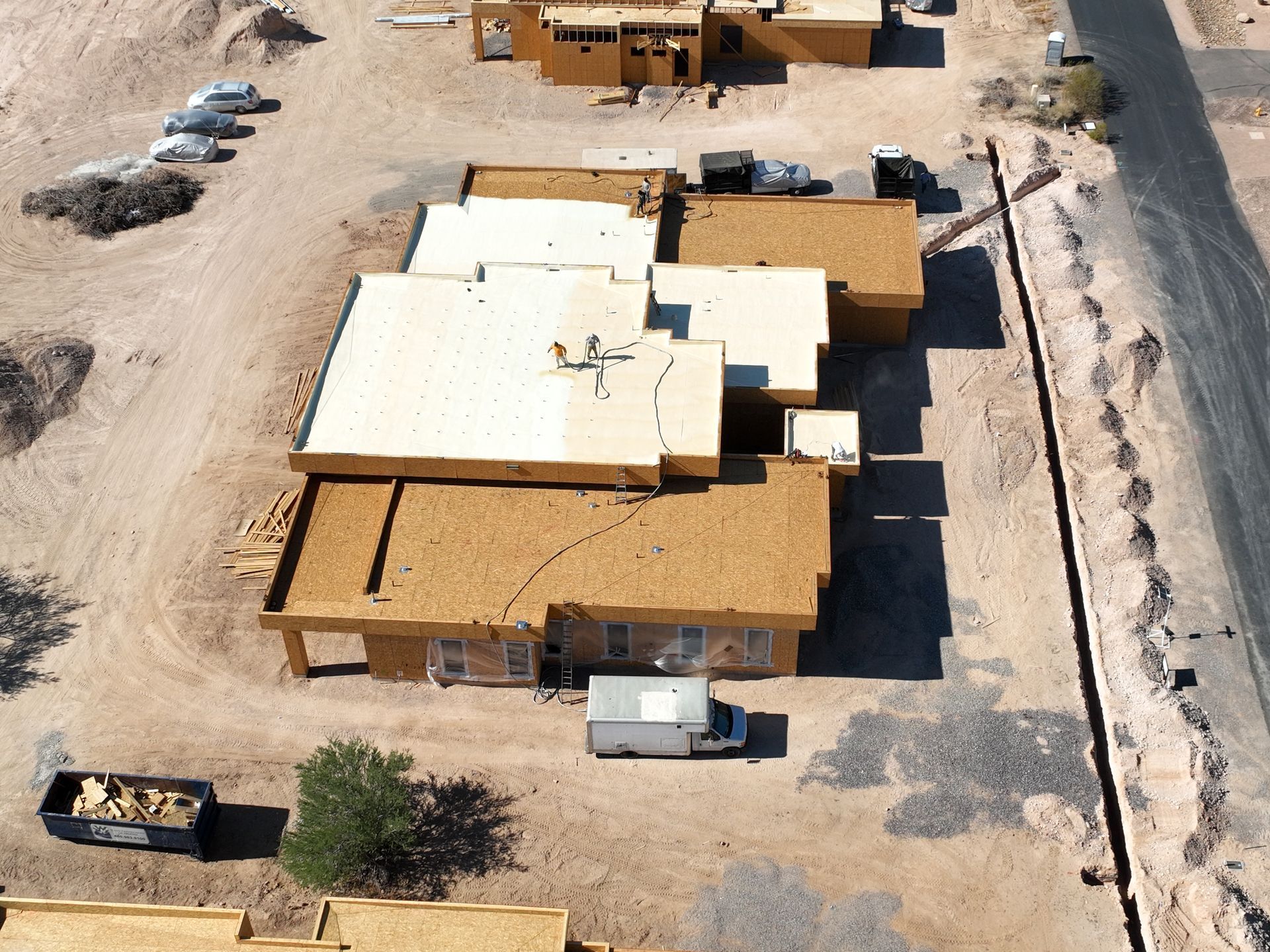 An aerial view of a building with a white roof.