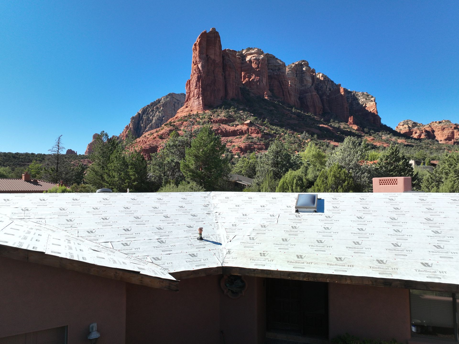 A white roof with a mountain in the background.