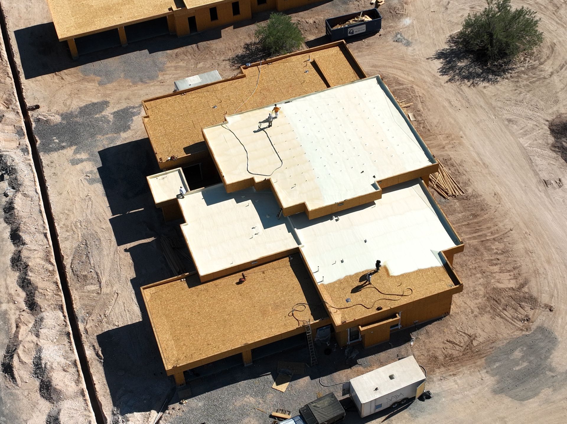 An aerial view of a house under construction in the desert.