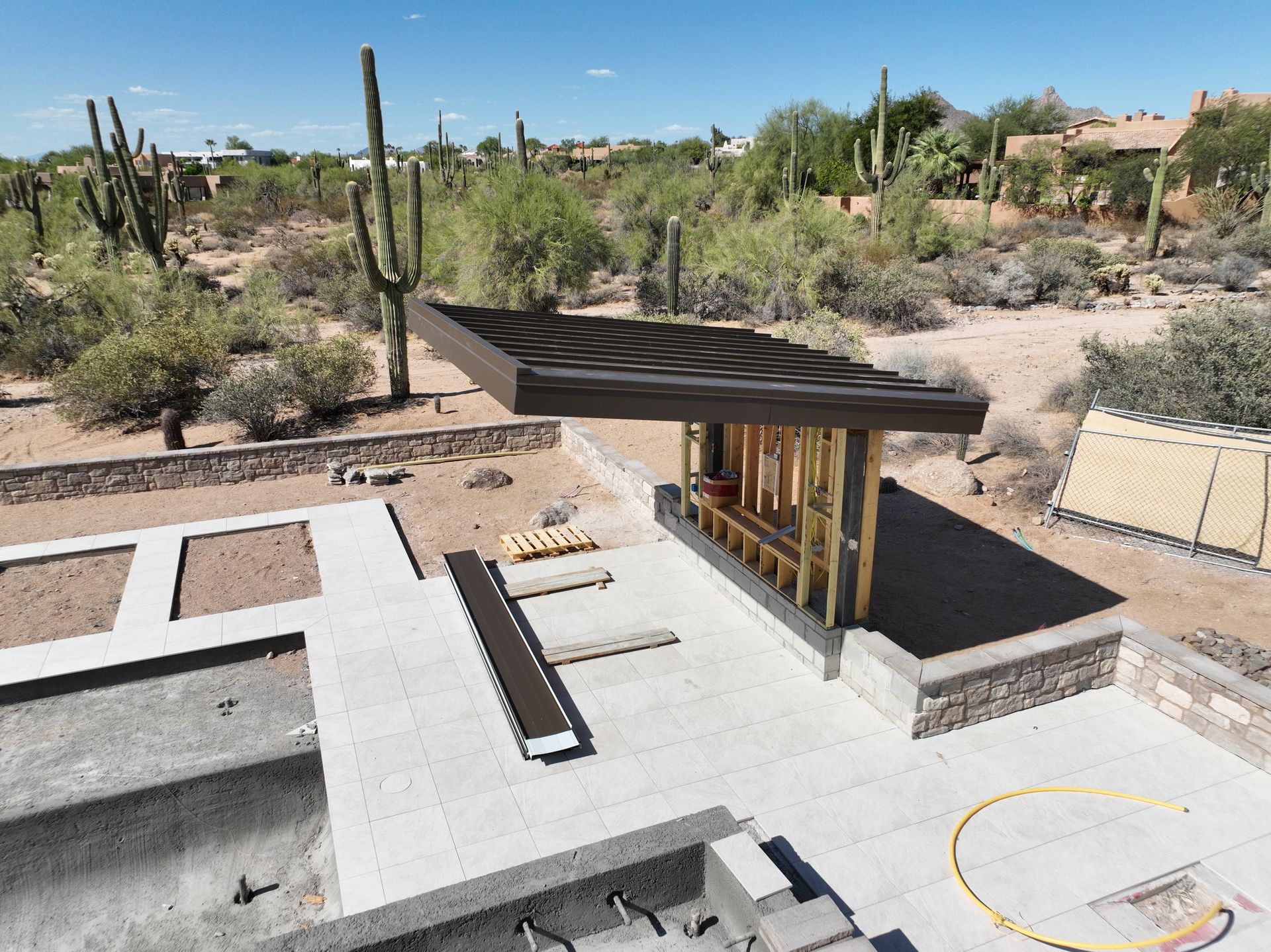 An aerial view of a house under construction in the desert.