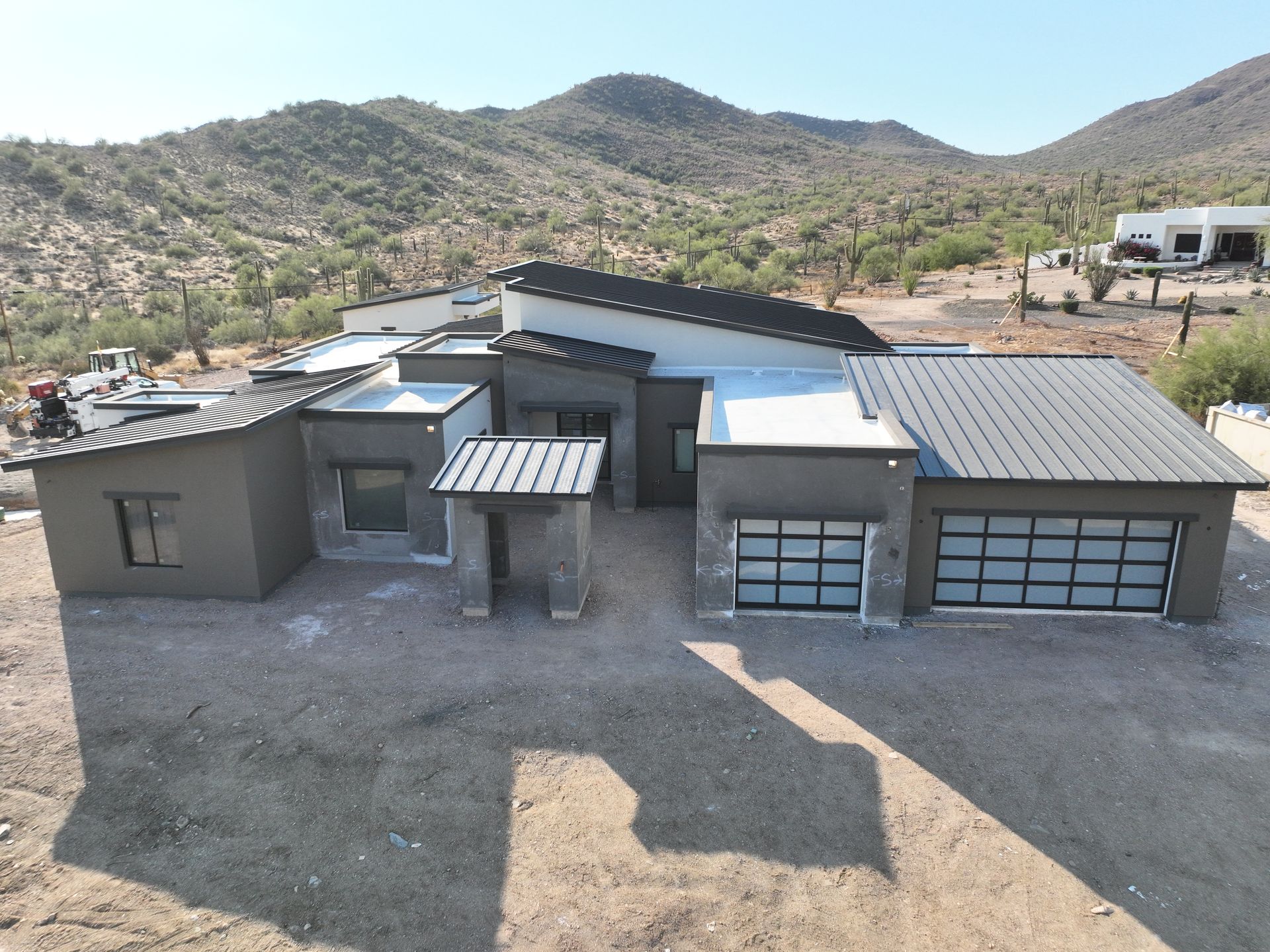 An aerial view of a house with mountains in the background.
