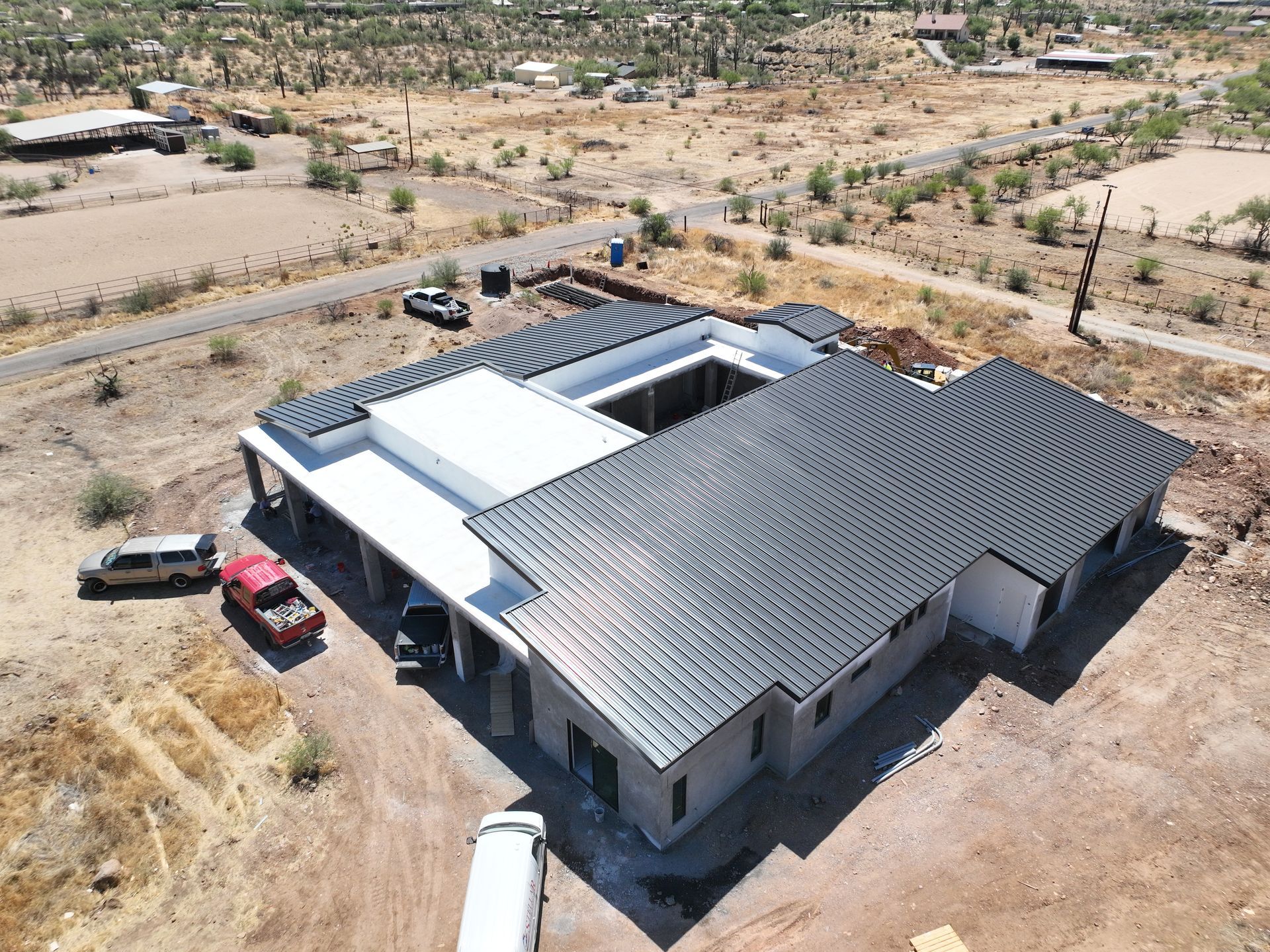 An aerial view of a house under construction in the desert.