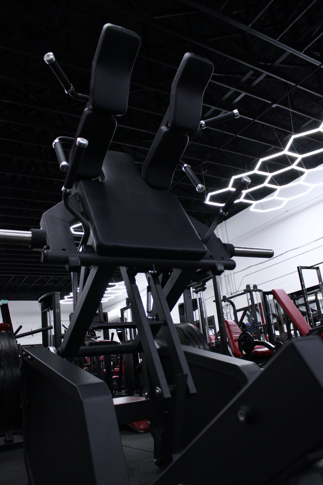 A gym with a lot of exercise equipment and a bench.