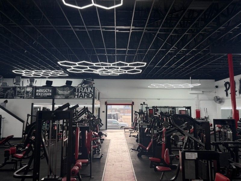 A gym with a sign that says 'train hard ' on it