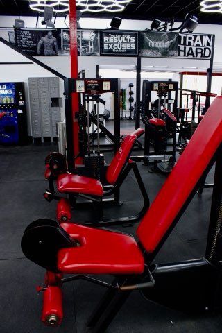 A gym with a sign that says train hard