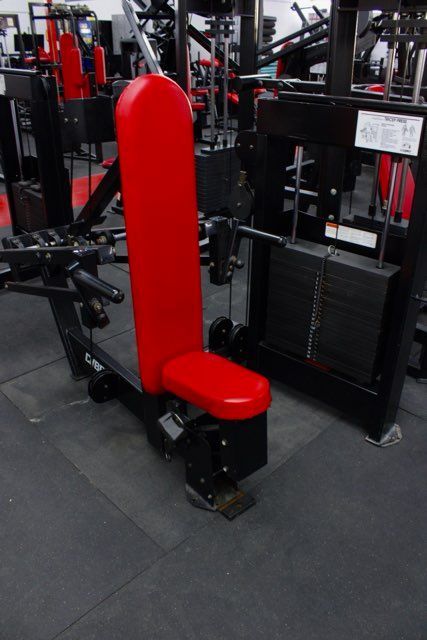 A red and black exercise machine in a gym