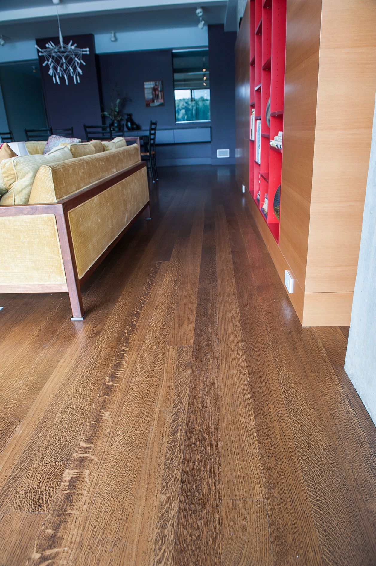 a living room with a wooden floor and a couch